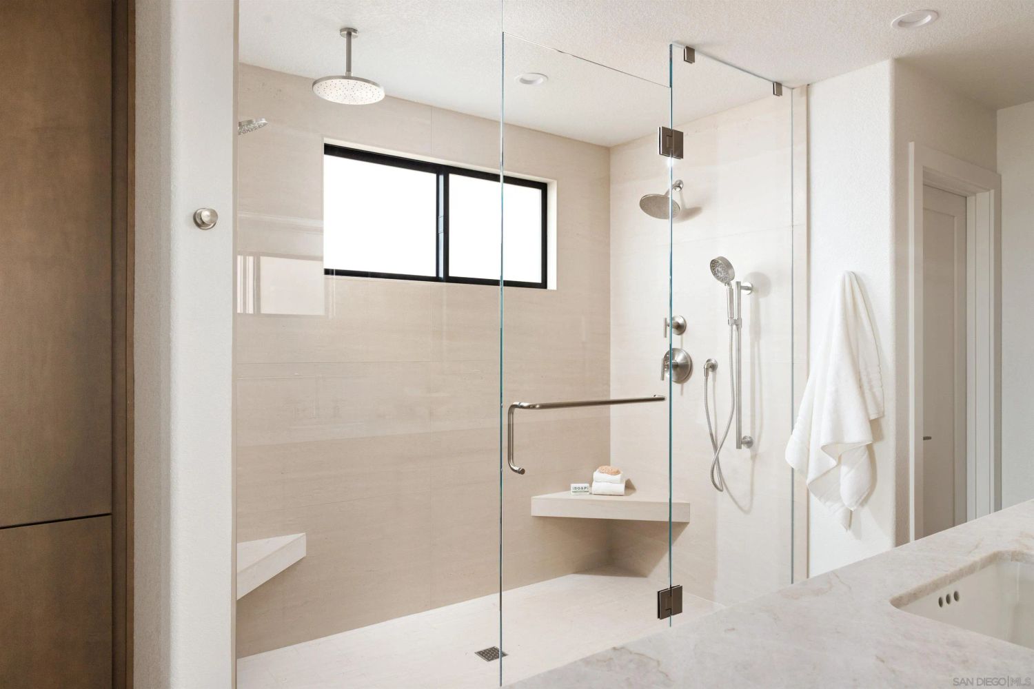 Walk-in glass shower with ceiling rain head