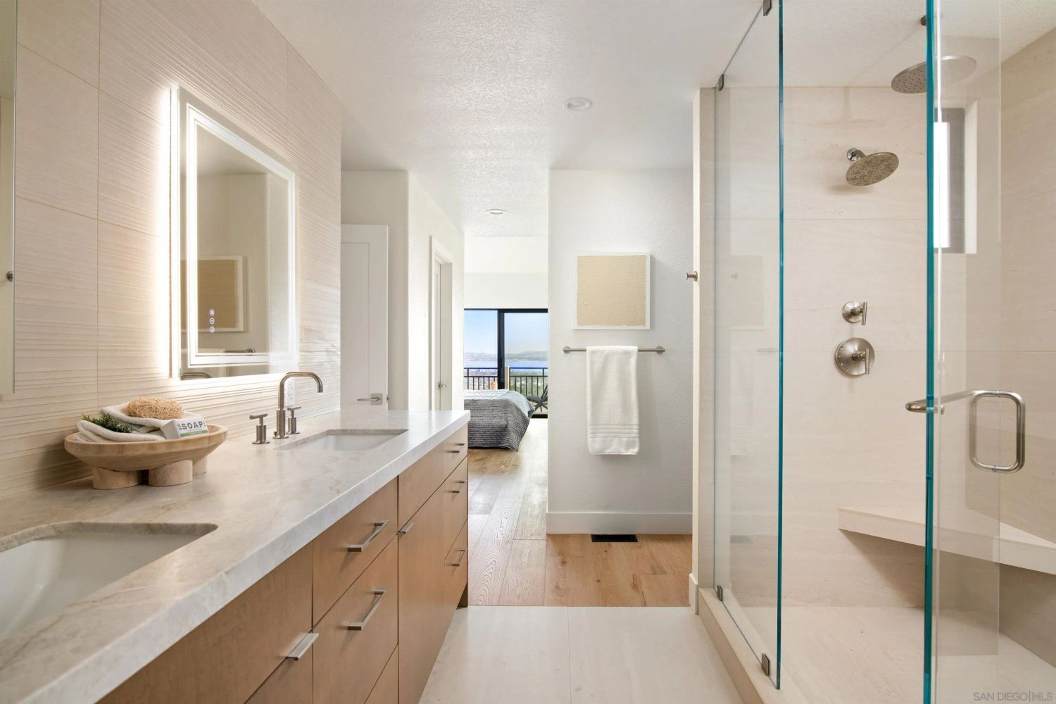 Primary suite bathroom with views to bedroom