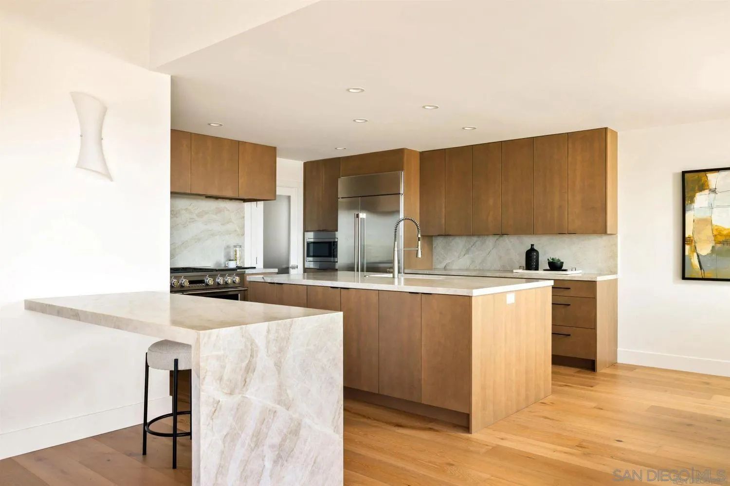 Custom kitchen with wood cabinetry and marble island