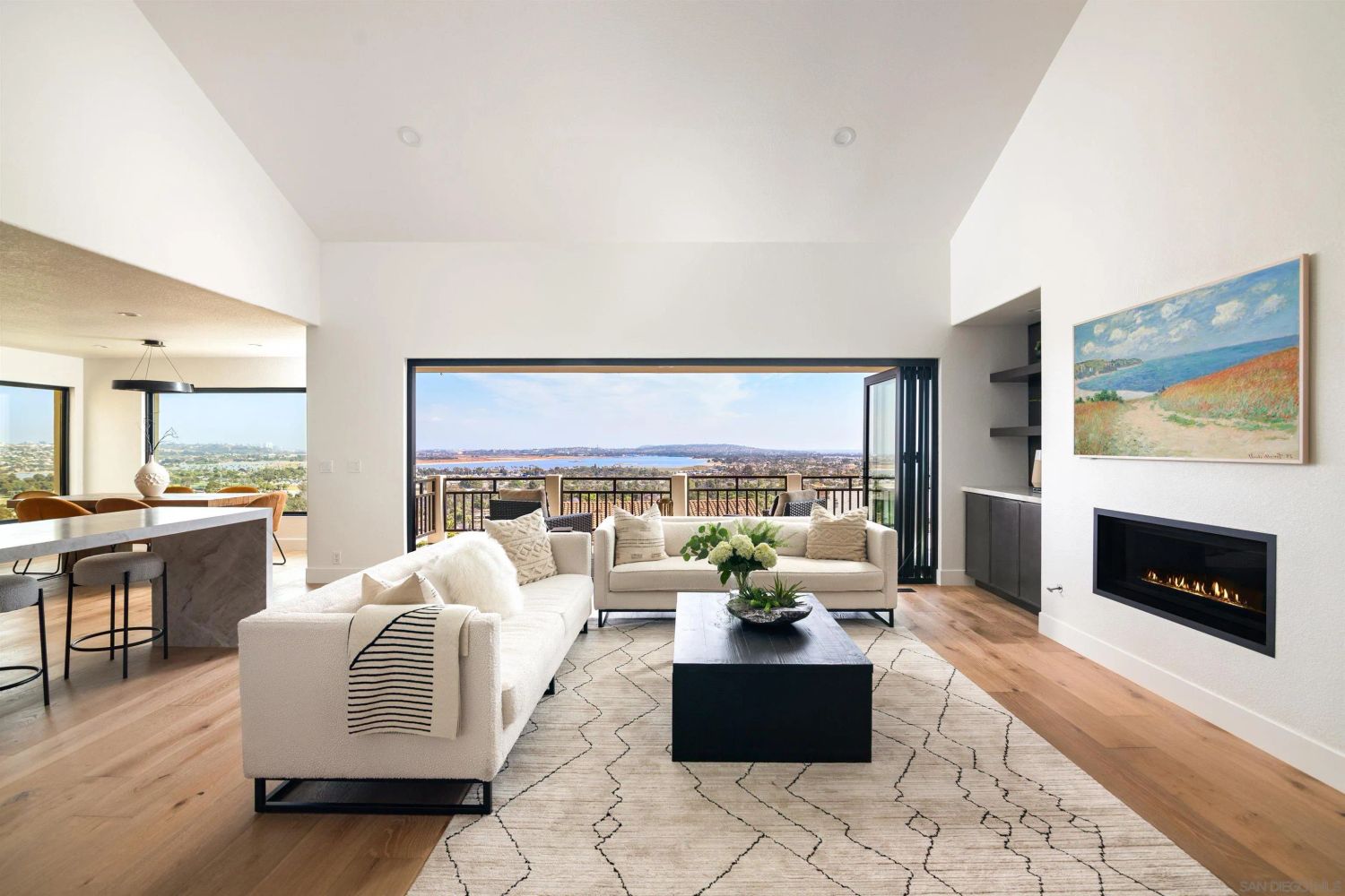 Open living room with bay views and fireplace